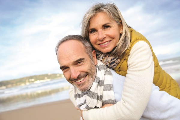 Senior man giving piggyback ride to wife